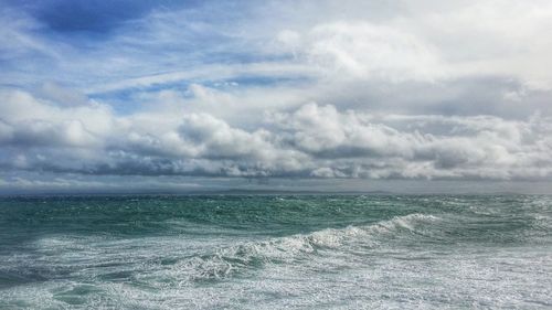 Scenic view of sea against cloudy sky