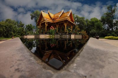 Surface level shot of temple reflecting in pond