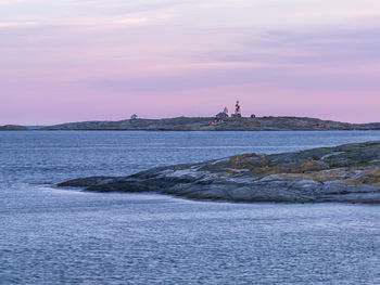 Rocky coast, lighthouse on background