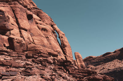 Low angle view of rock formation against clear sky