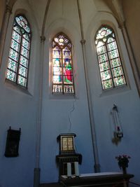 Low angle view of glass window of building