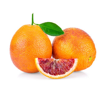 Close-up of orange fruit against white background