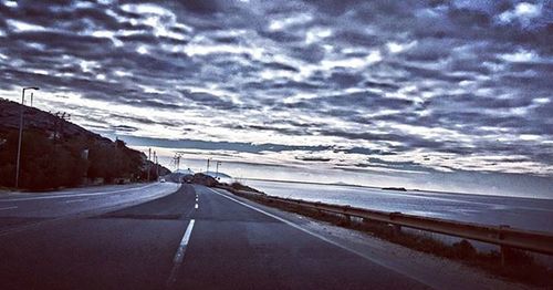 View of road against cloudy sky