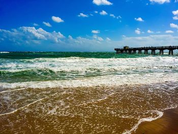 View of beach against cloudy sky