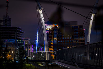 Low angle view of suspension bridge at night