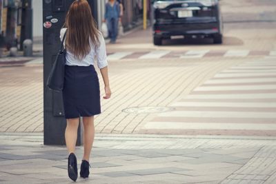 Rear view of woman walking outdoors