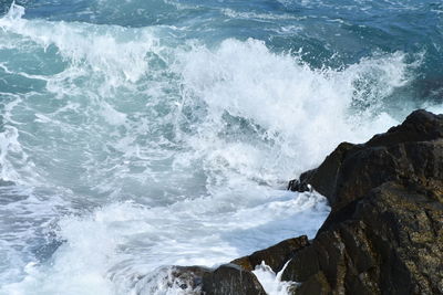 Waves splashing on rocks at shore