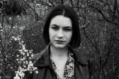 Portrait of beautiful woman against trees