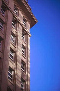 Low angle view of building against clear blue sky