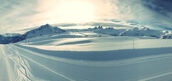 Scenic view of snow covered mountains against sky