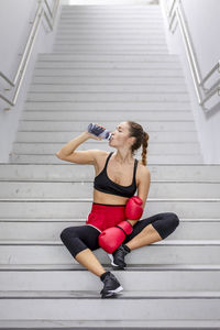 Thirsty female athlete drinking water