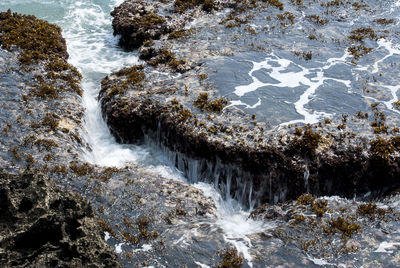 Water flowing through rocks in sea