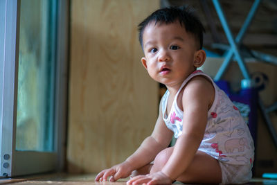 Portrait of cute boy sitting at home