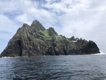 Scenic view of sea and rock formation against sky