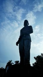 Low angle view of statue against cloudy sky