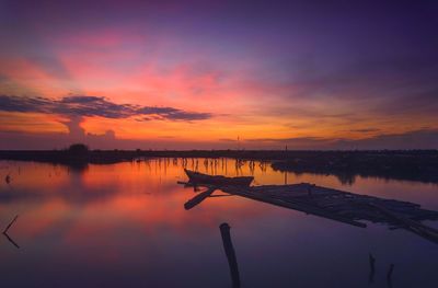 Scenic view of lake against romantic sky at sunset