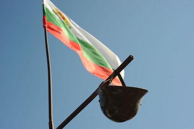 Low angle view of flag against blue sky