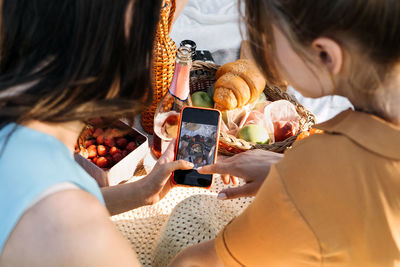 High angle view of woman holding mobile phone