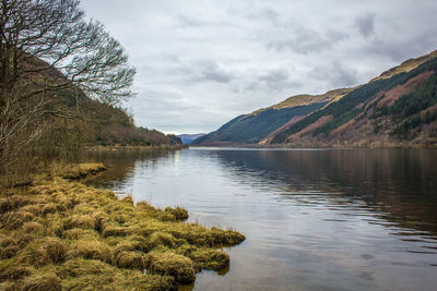 Scenic view of lake against cloudy sky