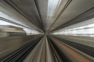 Blurred motion of train at railroad station