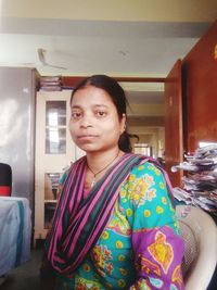 Portrait of woman sitting at home