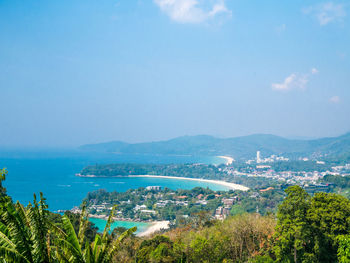 High angle view of townscape by sea against sky