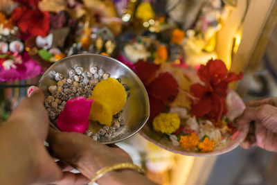 Cropped image of people with religious offerings during holi