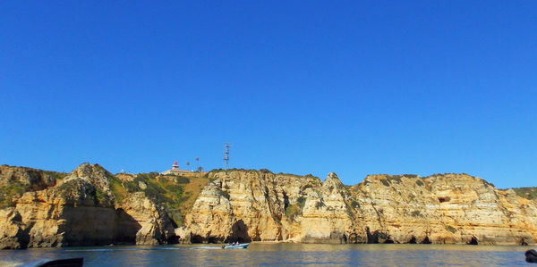 Scenic view of sea against clear blue sky