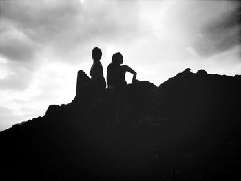 Low angle view of silhouette people against sky