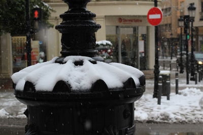 Close-up of snow on street in city