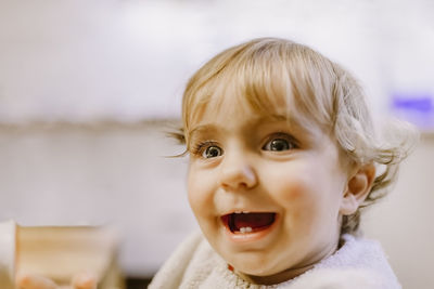 Close-up of cute cheerful girl looking away