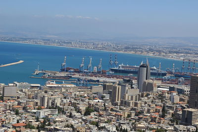 High angle view of buildings by sea against sky