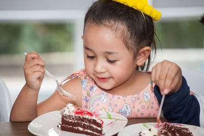 Close-up of girl eating birthday cake