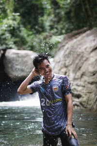 Full length of man splashing water