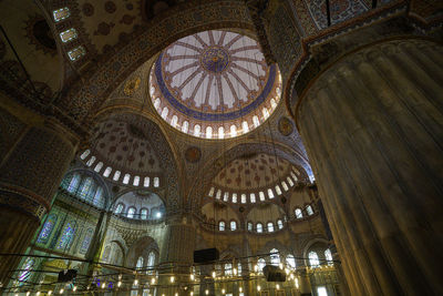 Low angle view of illuminated cathedral in city, blue mosque, istanbul