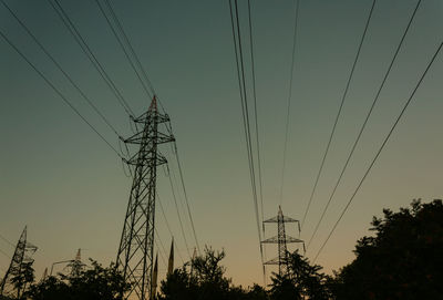 Low angle view of electricity pylon against sky