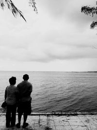 Rear view of man looking at sea