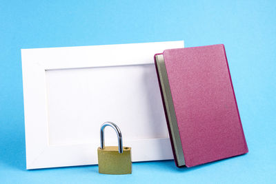 Close-up of books on table against blue background