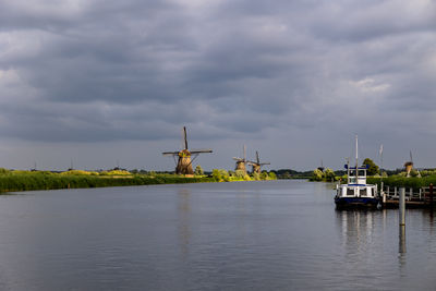 Beautiful wooden windmills at sunset in the dutch village of kinderdijk. windmills run on the wind.