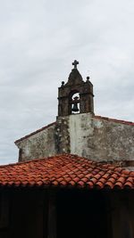 Low angle view of bell tower against sky