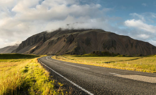 Winding road at the side of the mountain in rural part of east iceland