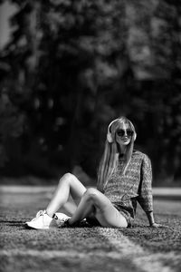 Portrait of young woman sitting outdoors