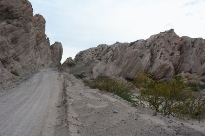 Road amidst mountains against clear sky