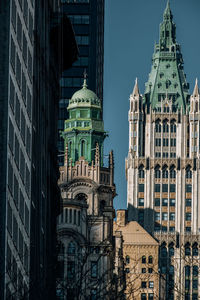 Low angle view of buildings in city against sky