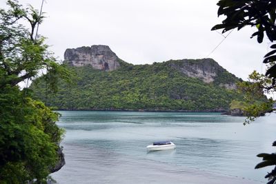 Scenic view of sea and mountains against sky