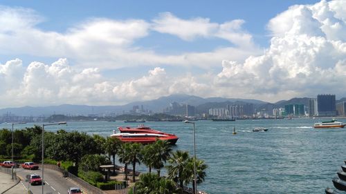 View of boats in sea against cloudy sky