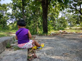 Girl sitting on tree