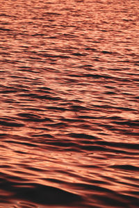 Full frame shot of rippled water during sunset 