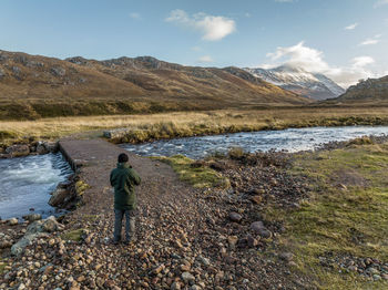 Rear view of man walking on mountain