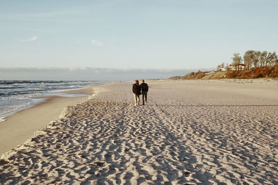 People on beach against sky